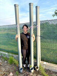 Campaign Manager Kate with drainpipe animal feeders in Ukraine
