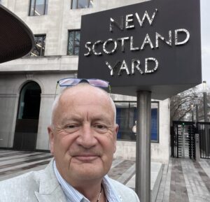 Mark at Scotland Yard: Image shows Campaign Manager, Mark Randell, smiling outside the New Scotland Yard sign.