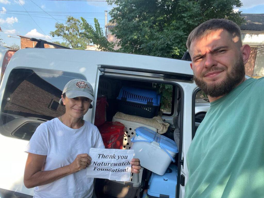 The war in Ukraine: How Naturewatch Foundation has been supporting animals in crisis 6 A man and woman are smiling, standing in front of a white van, which is full of animal carriers and boxes. The woman holds a sign saying, ‘Thank you Naturewatch Foundation’.
