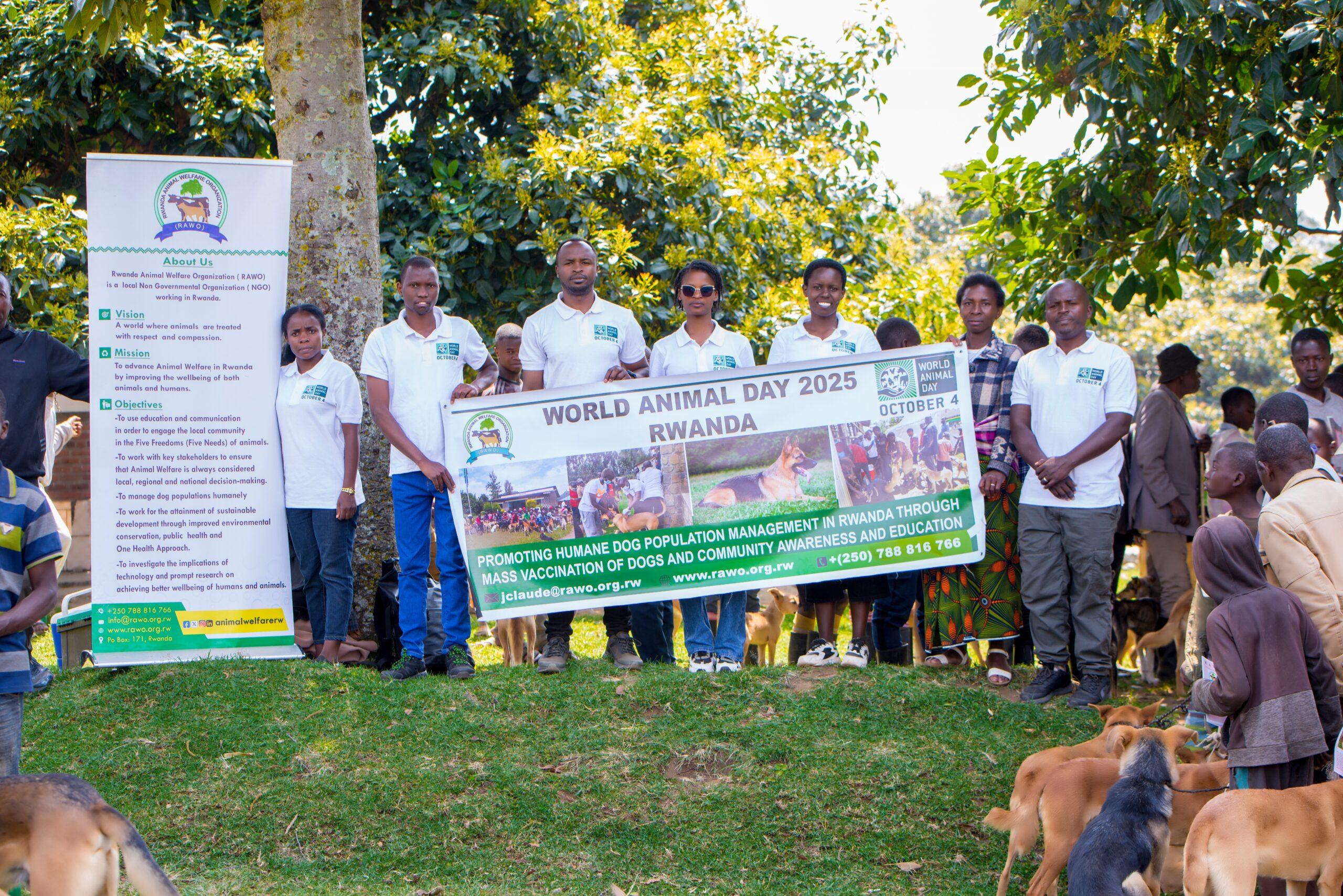 How you can help 3 Members of the Rwanda Animal Welfare Organisation (RAWO) holding a World Animal Day 2025 banner promoting humane dog population management and vaccination in Rwanda.