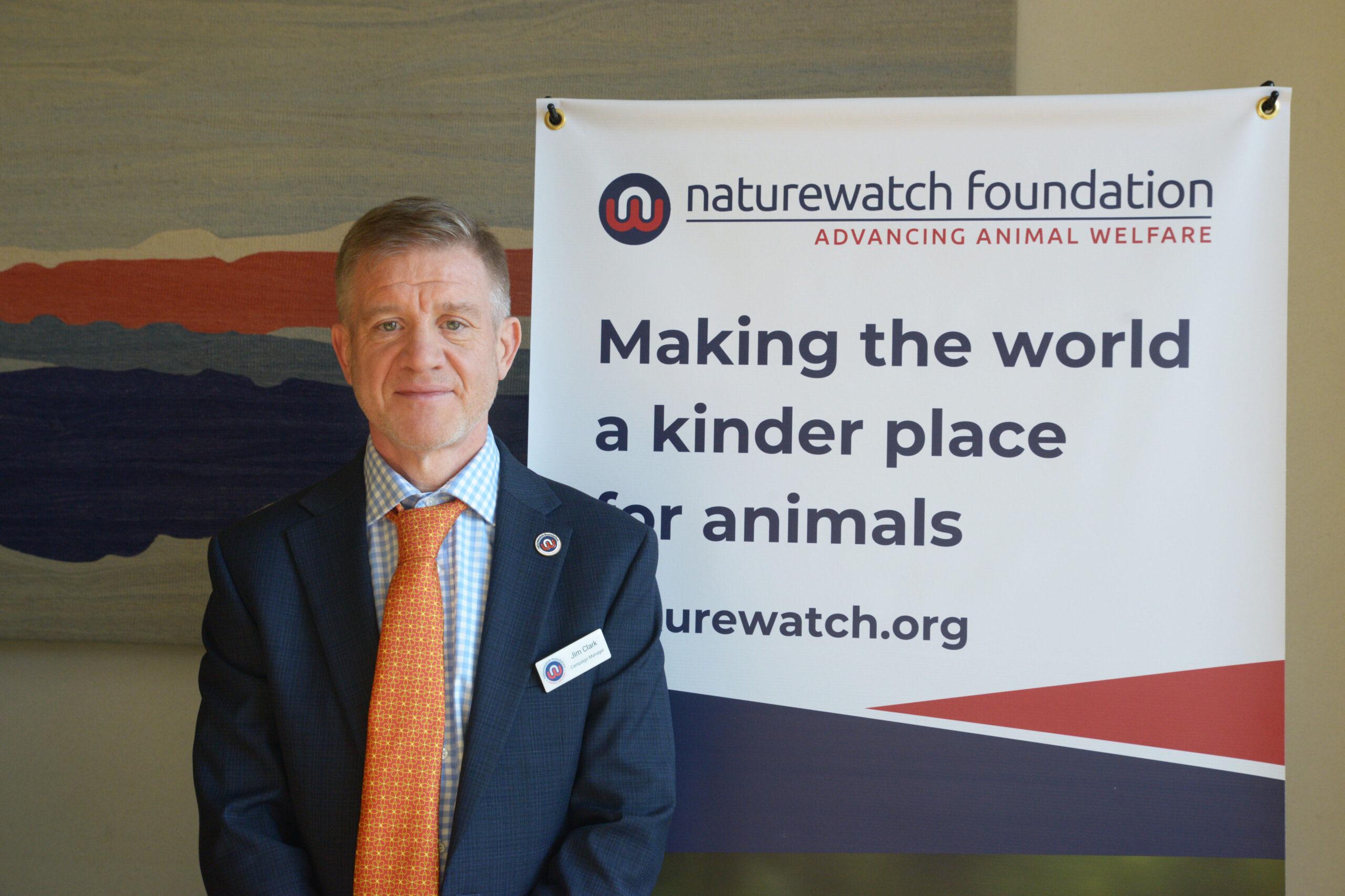 Target Crime Not Wildlife Parliamentary MP drop-in session 1 Jim our campaign manager at our parliamentary drop-in in front of our "making the world a kinder place for animals" sign.