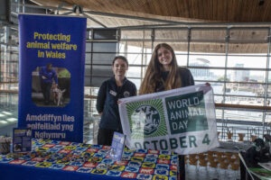 Natalie from Naturewatch with Sioned from the RSPCA holding the World Animal Day flag.
