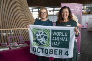 Sarah Naturewatch CEO with Vanessa Hope Rescue CEO with the World Animal Day flag.