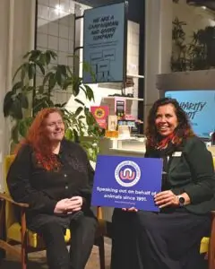 Hilary and Sarah sat in LUSH holding our Naturewatch Foundation logo board. 